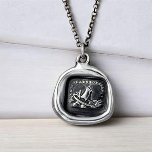 a necklace with a picture of a boat on it
