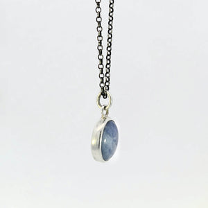 Light blue sapphire pendant in sterling silver bezel