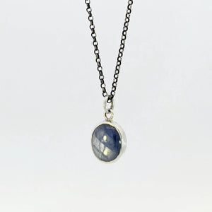 Light blue sapphire pendant in sterling silver bezel
