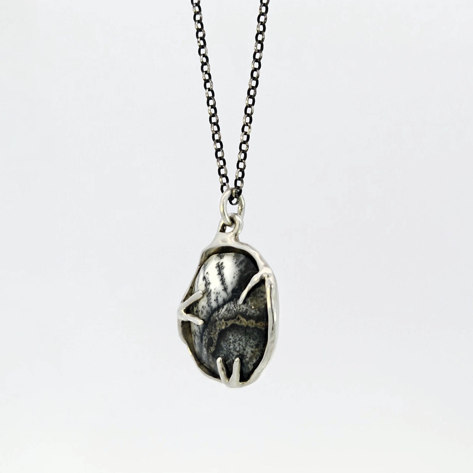 Dendritic opal pendant in hybrid bezel with decorative prongs