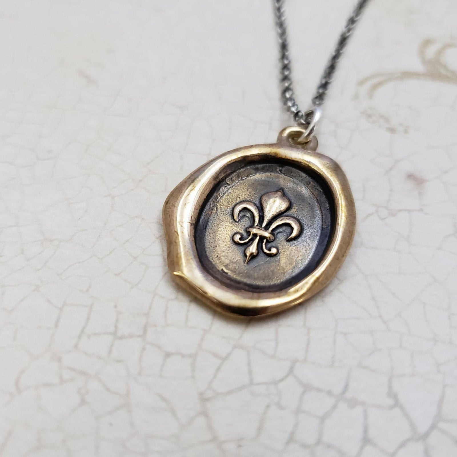 Fleur de lis Purity Crest in Bronze