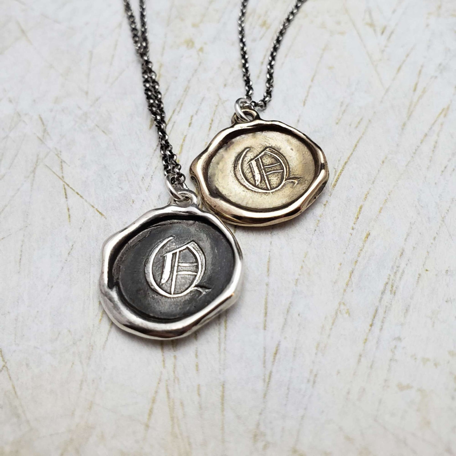 Initial Q in Bronze