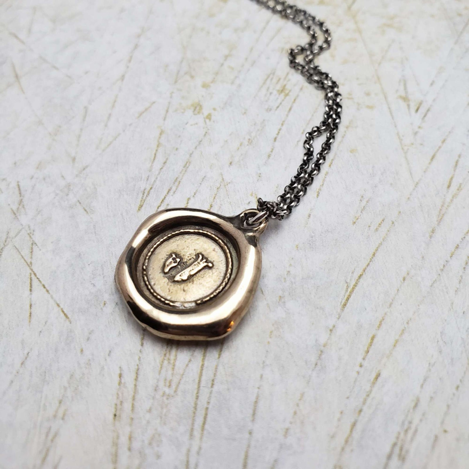 Initial J in Bronze