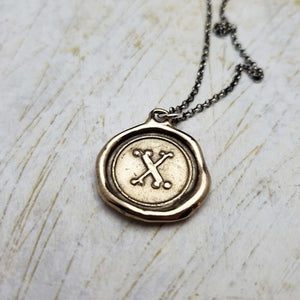 Initial X in Bronze