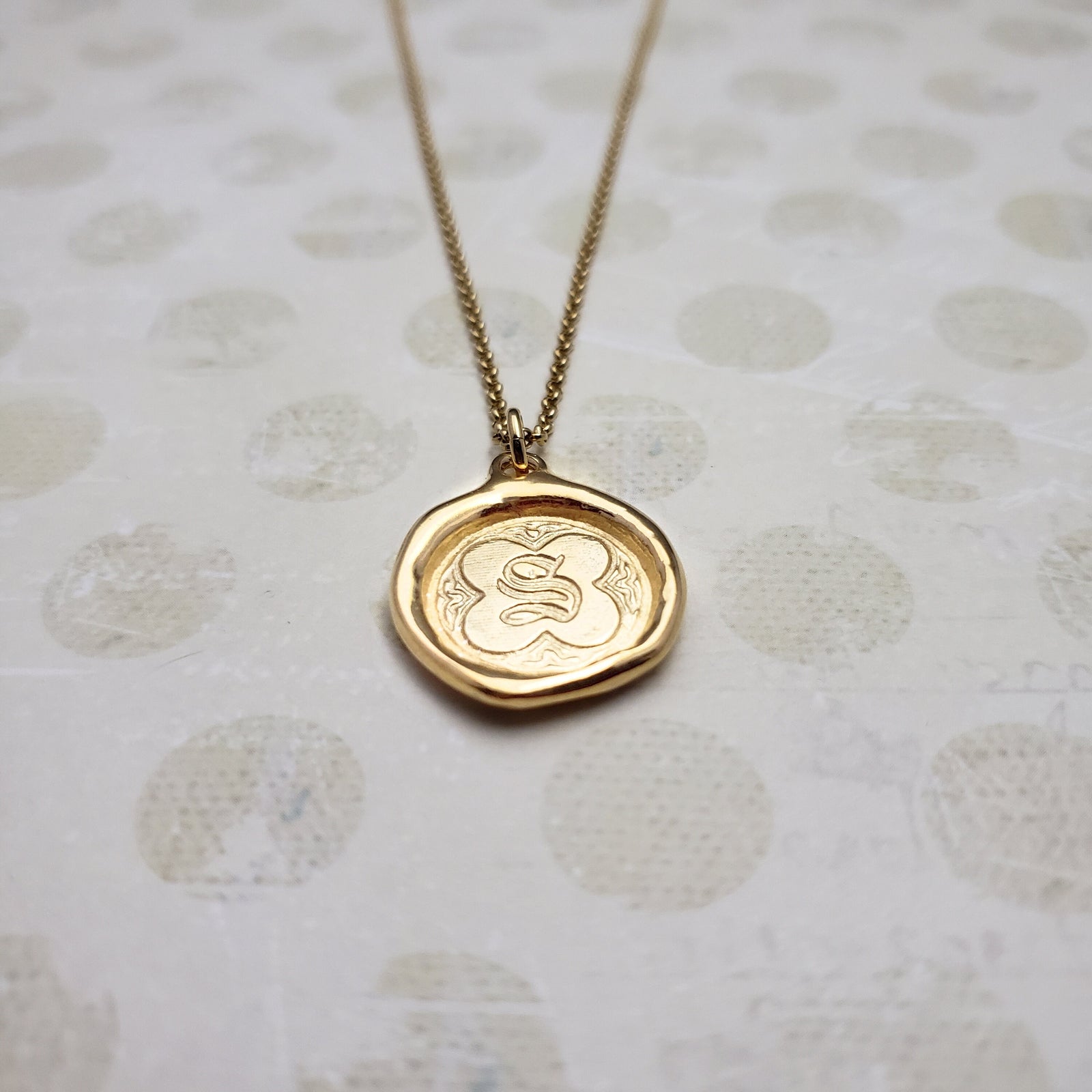 Letter S in gold vermeil