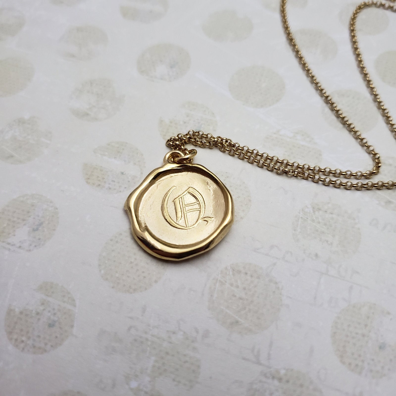 Letter Q in gold vermeil