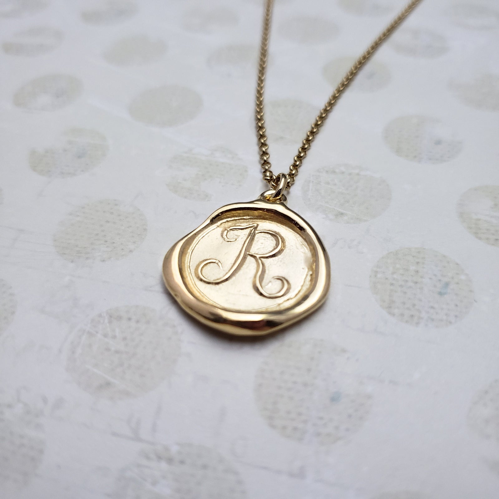 Letter R in gold vermeil