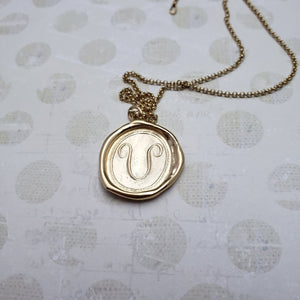 Letter U in gold vermeil