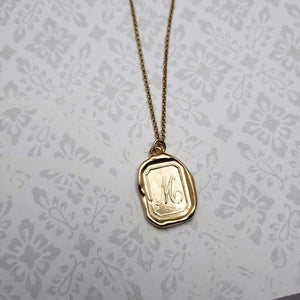Letter M in gold vermeil