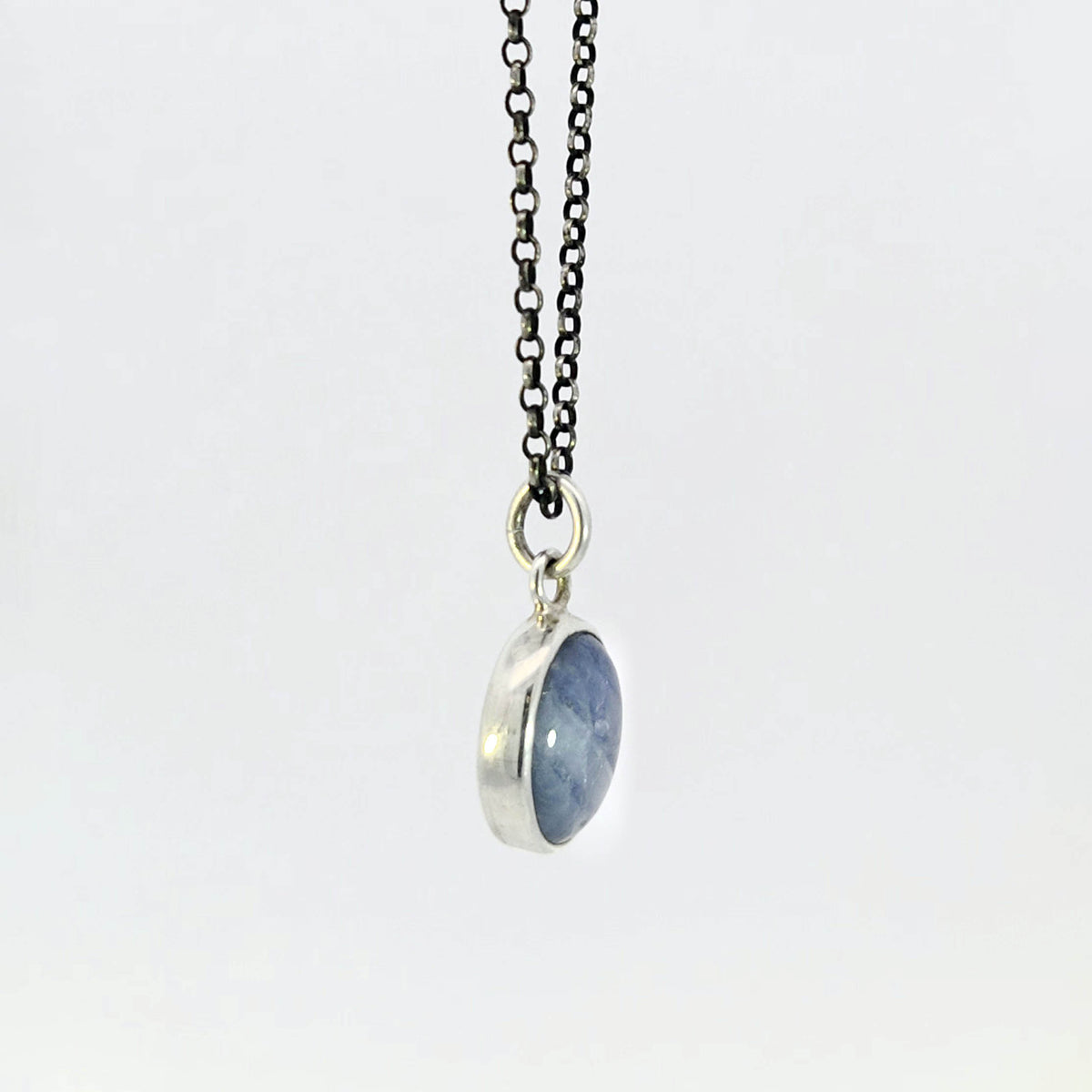Light blue sapphire pendant in sterling silver bezel