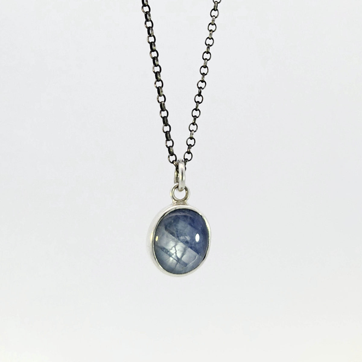 Light blue sapphire pendant in sterling silver bezel