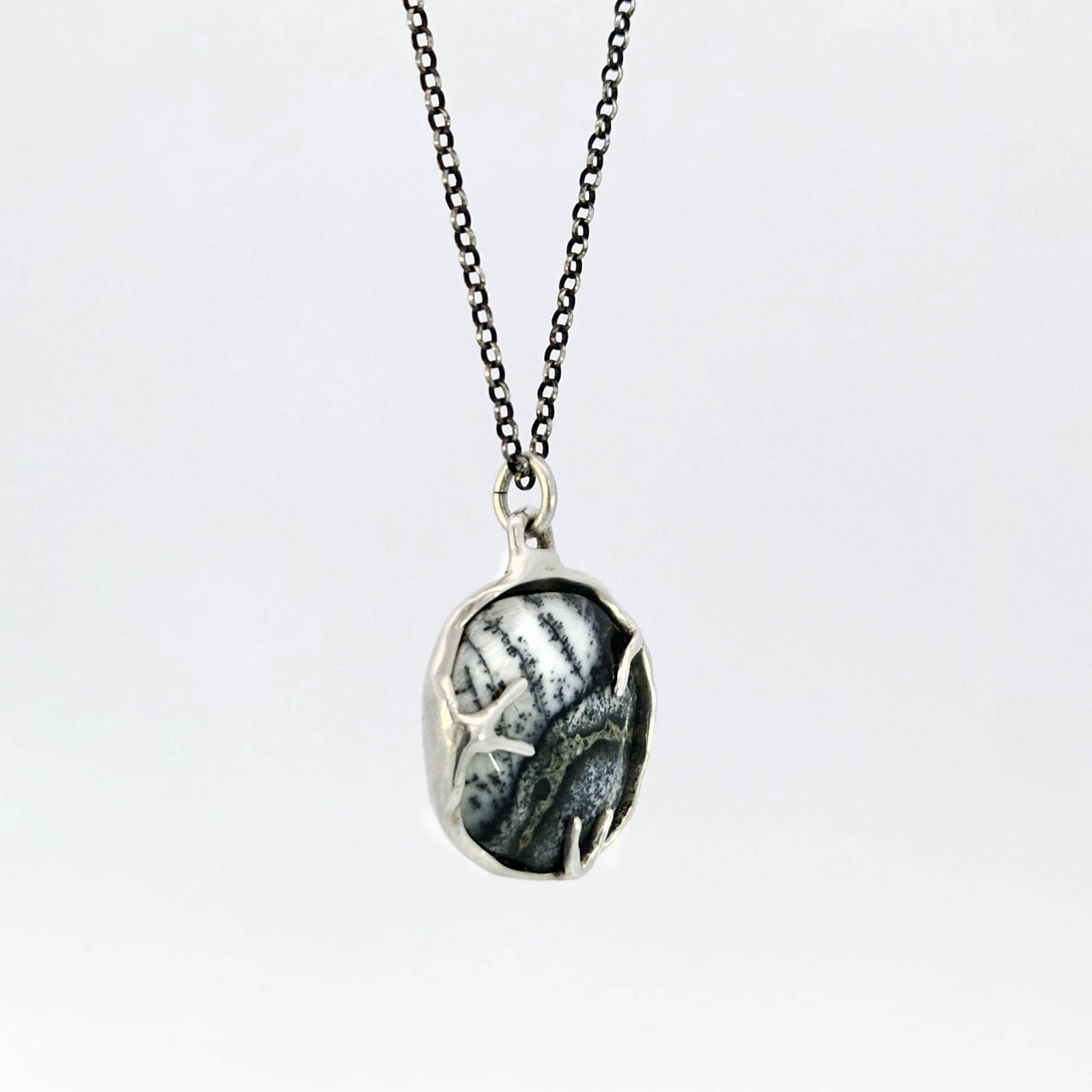 Dendritic opal pendant in hybrid bezel with decorative prongs