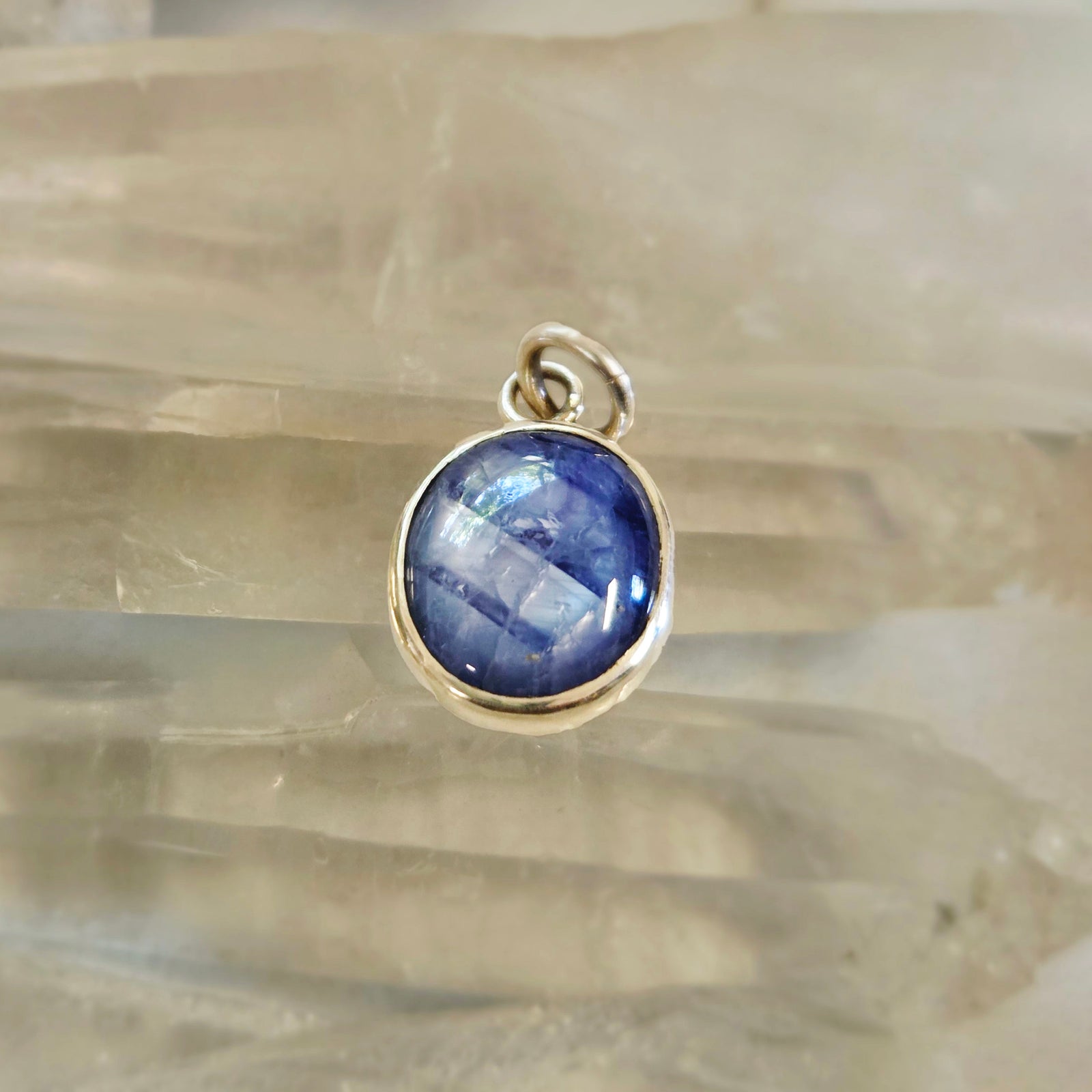 Light blue sapphire pendant in sterling silver bezel