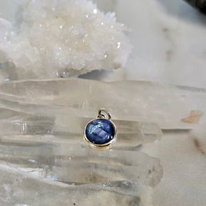 Light blue sapphire pendant in sterling silver bezel