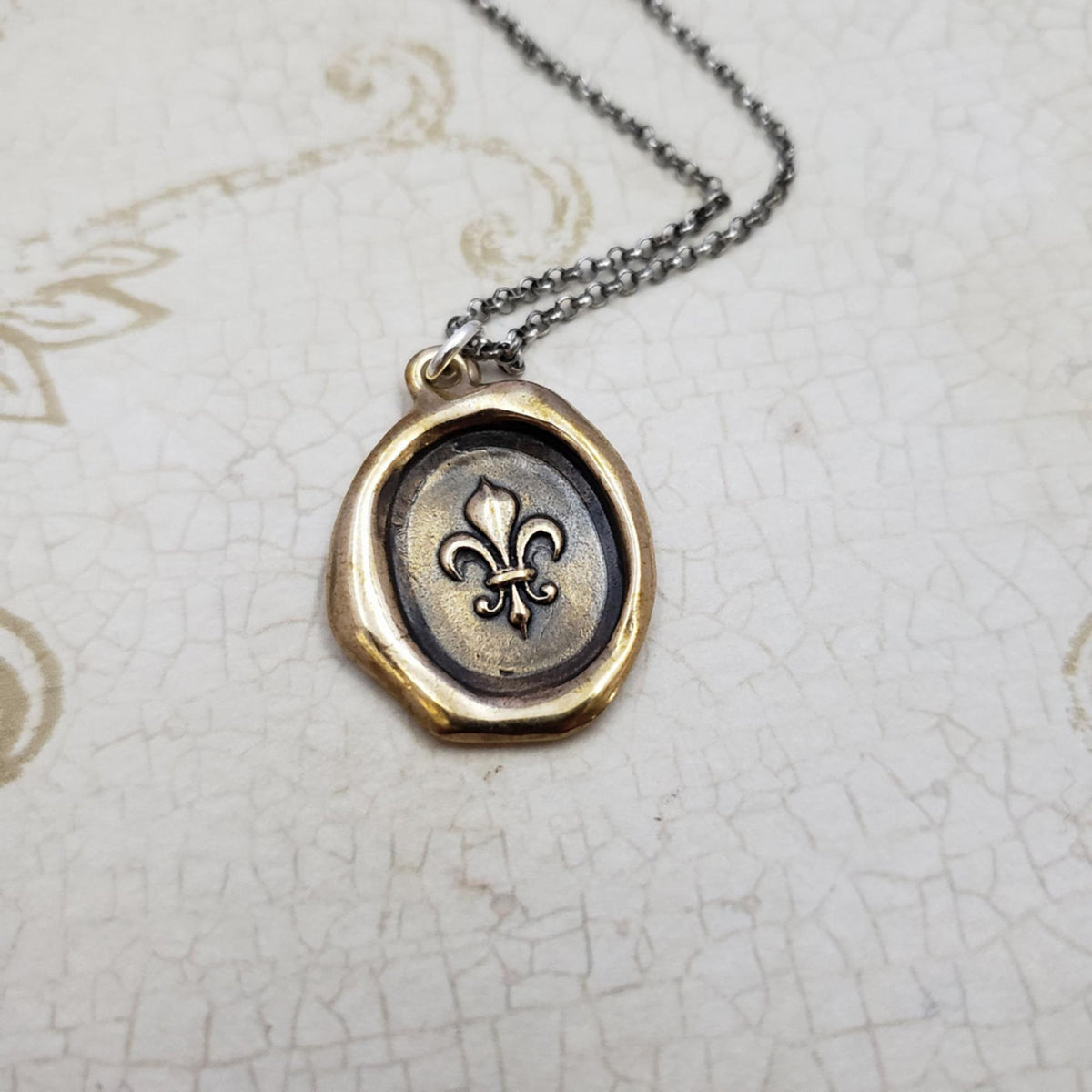 Fleur de lis Purity Crest in Bronze
