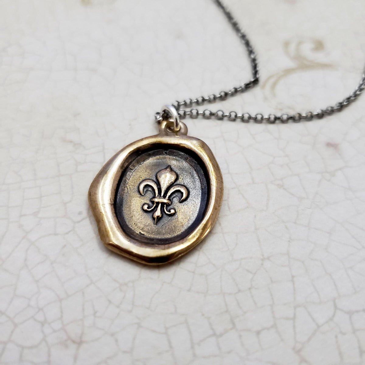 Fleur de lis Purity Crest in Bronze