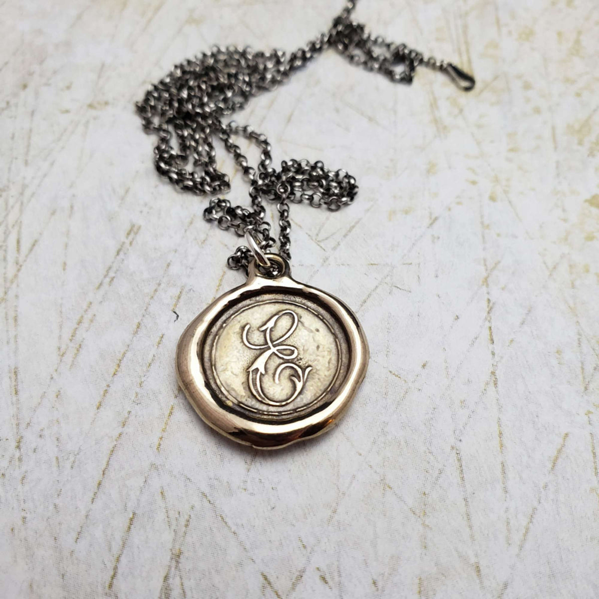 Initial E in Bronze
