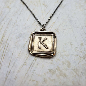 Initial K in Bronze