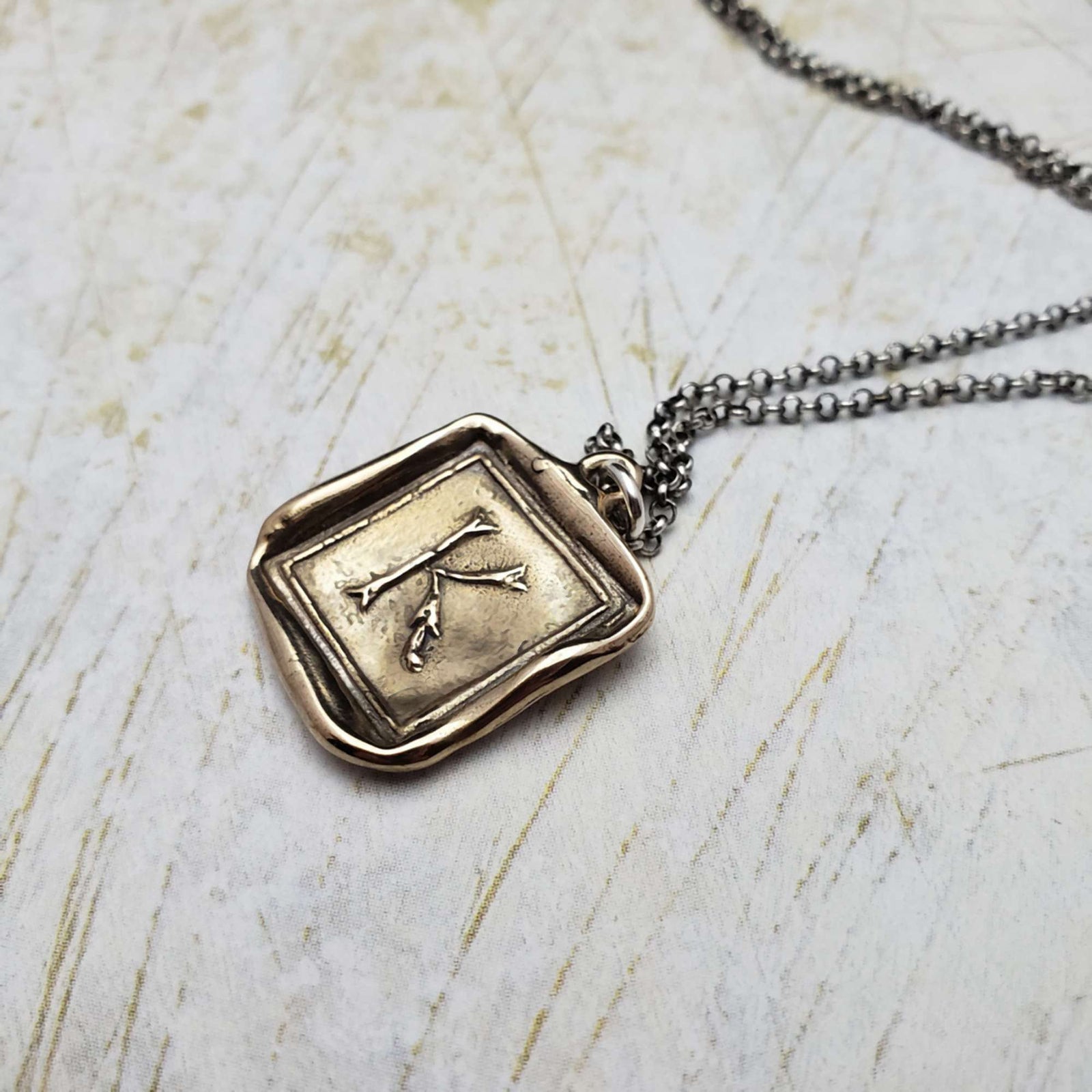 Initial K in Bronze