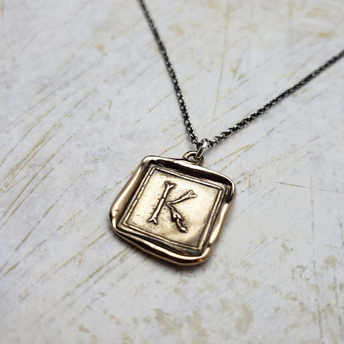 Initial K in Bronze