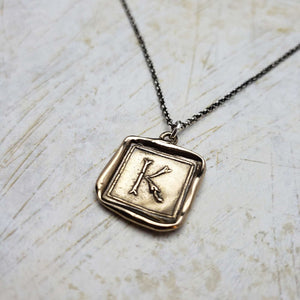 Initial K in Bronze