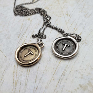 Initial T in Bronze