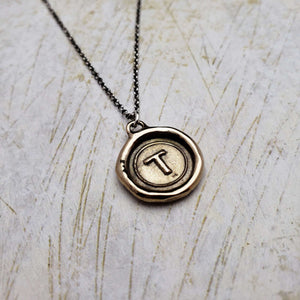 Initial T in Bronze