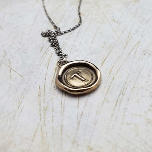 Initial T in Bronze