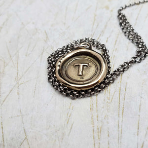 Initial T in Bronze