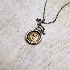 Initial T in Bronze