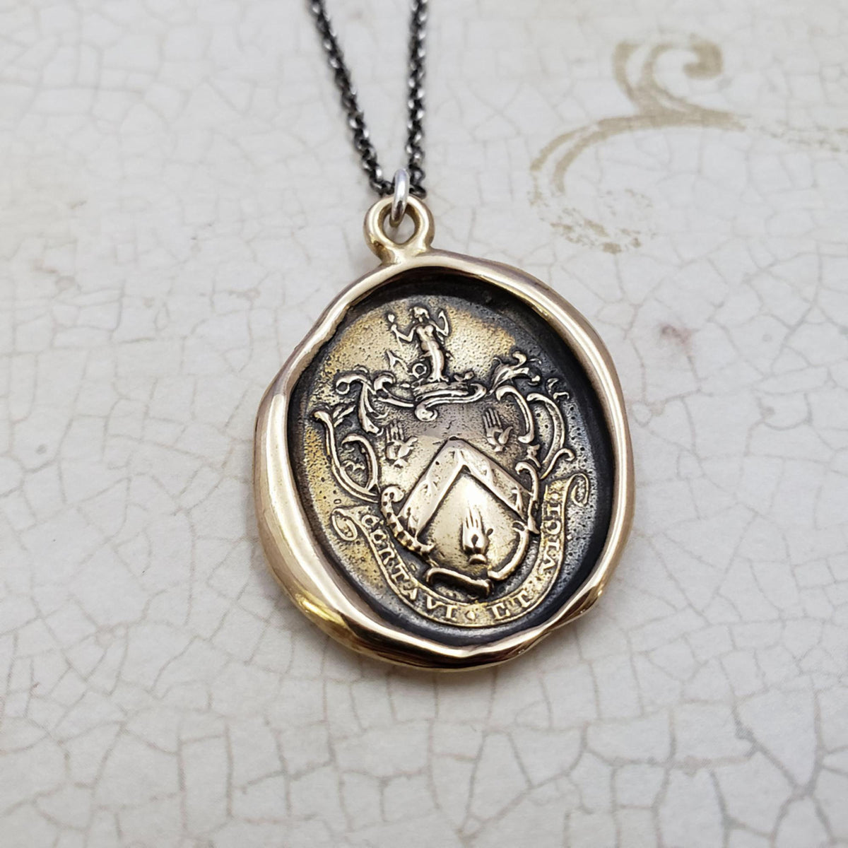 Mermaid - 'I have fought and conquered' in bronze