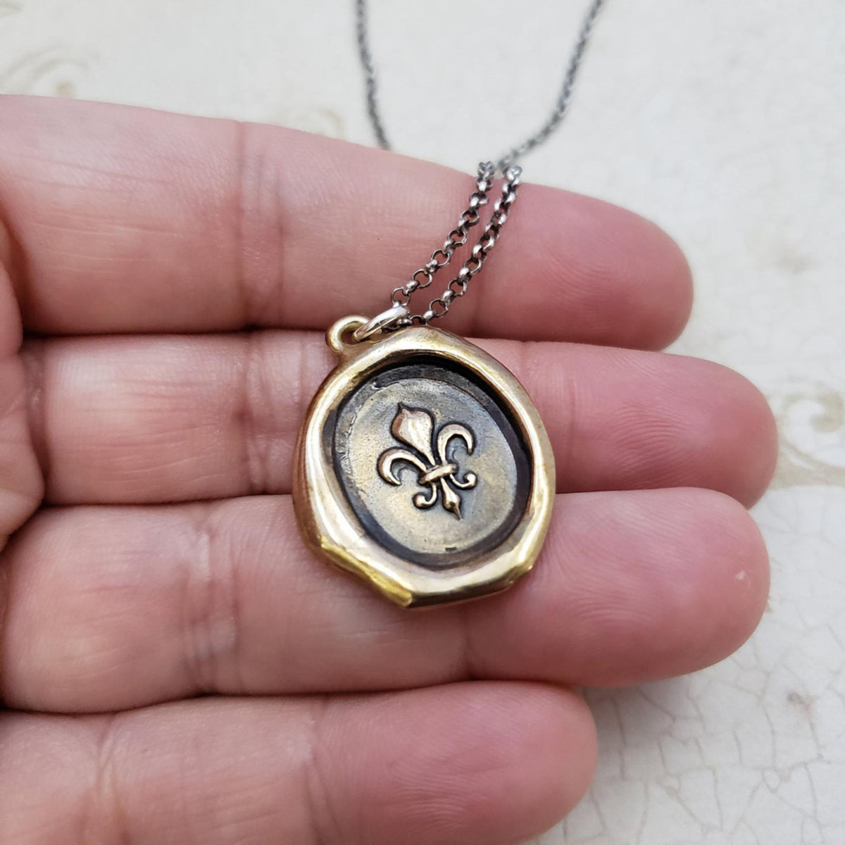Fleur de lis Purity Crest in Bronze