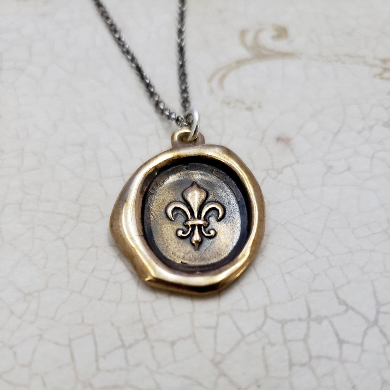 Fleur de lis Purity Crest in Bronze