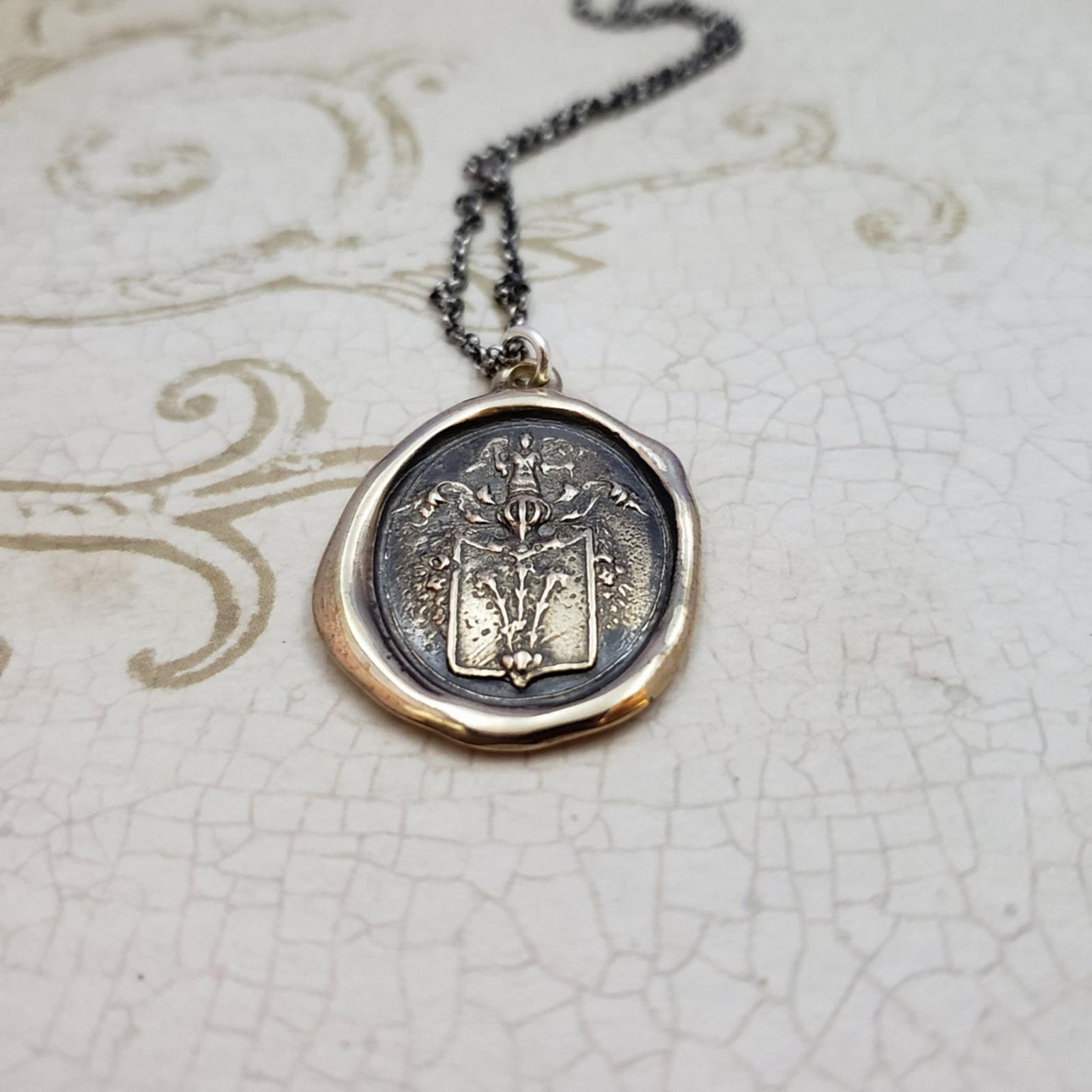 Angel and Fleur De Lis Crest in Bronze