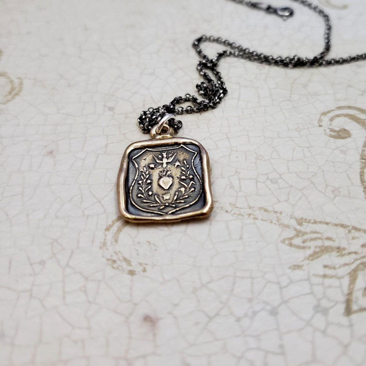 Swallow and Enflamed Heart Necklace in Bronze