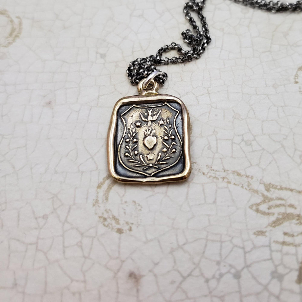 Swallow and Enflamed Heart Necklace in Bronze