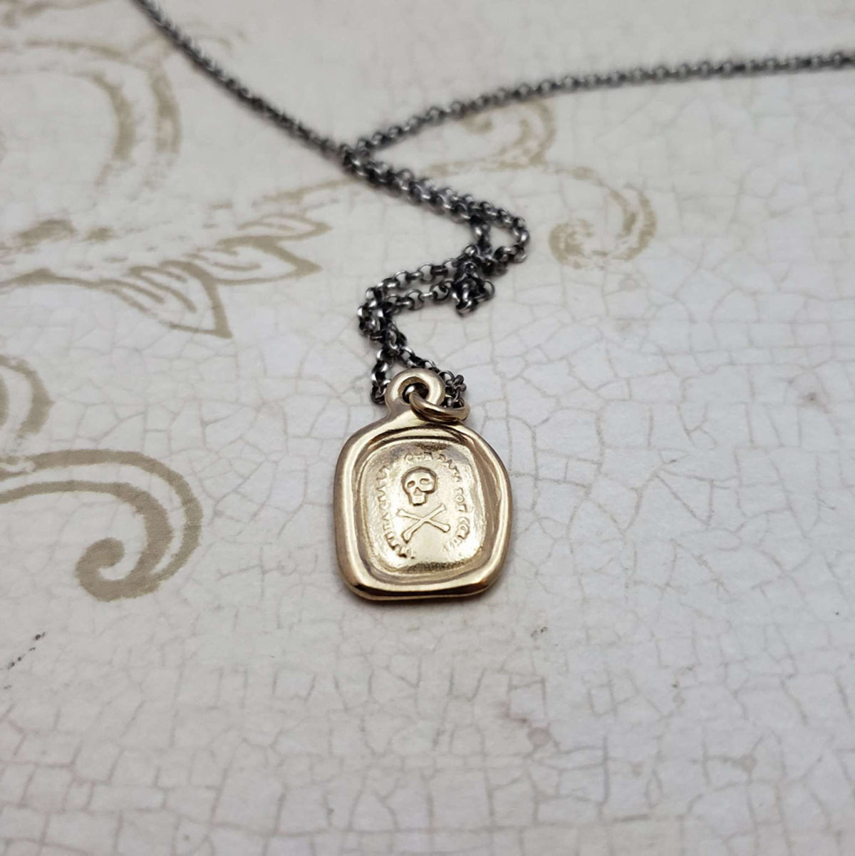 Skull &amp; Crossbones &#39;I do not fear your heart&#39; necklace in Gold Vermeil