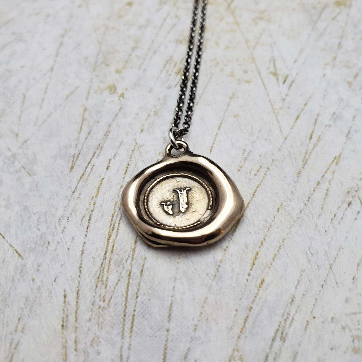 Initial J in Bronze