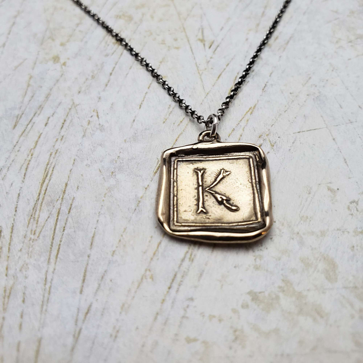 Initial K in Bronze