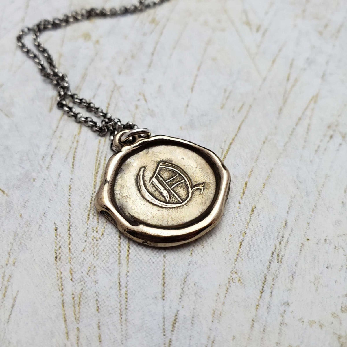 Initial Q in Bronze