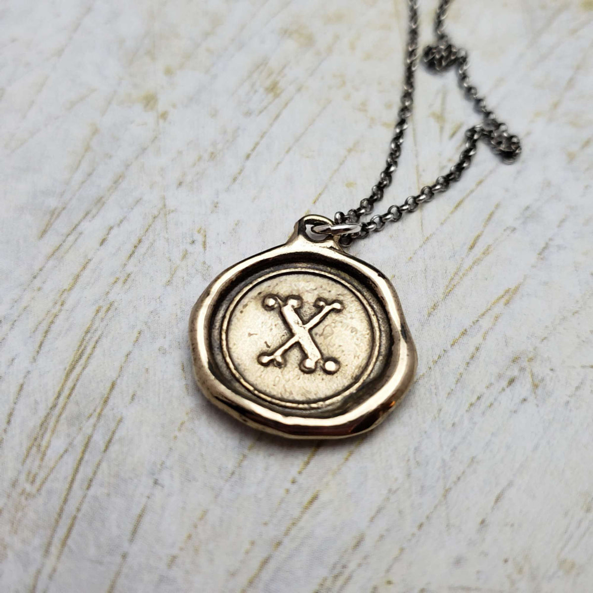 Initial X in Bronze