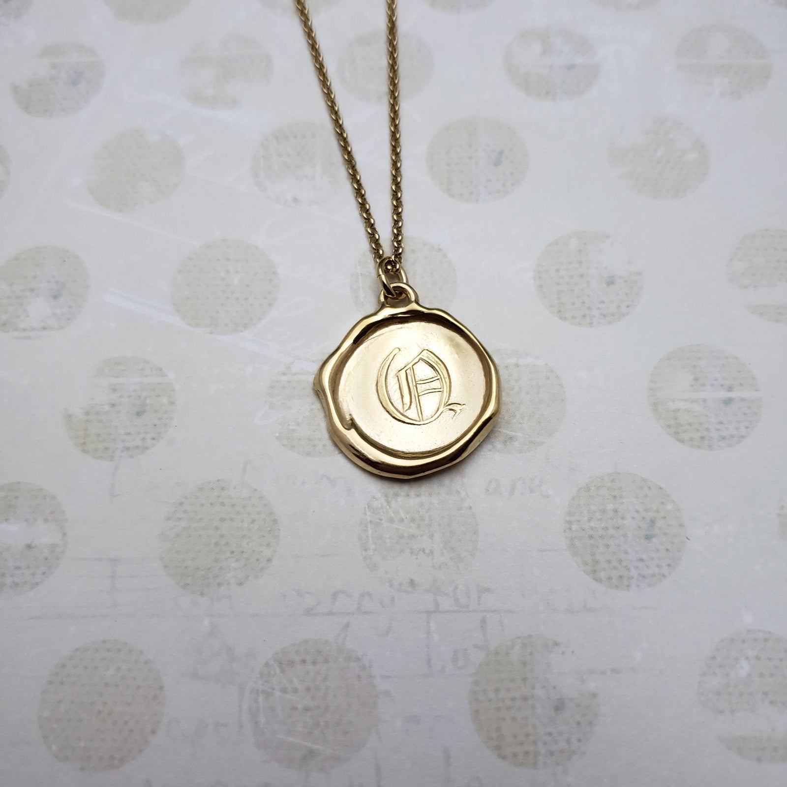 Letter Q in gold vermeil