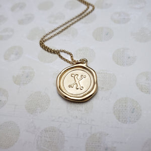 Letter X in gold vermeil