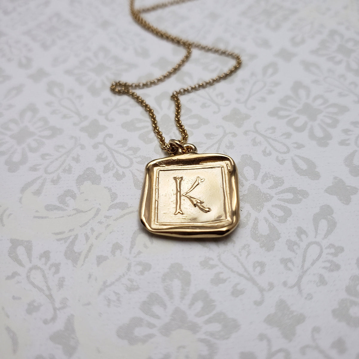 Letter K in gold vermeil