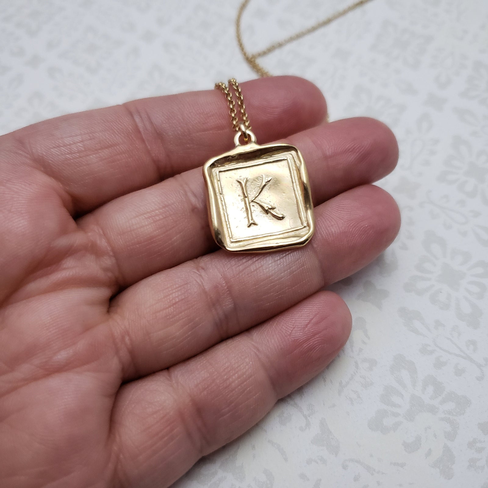 Letter K in gold vermeil