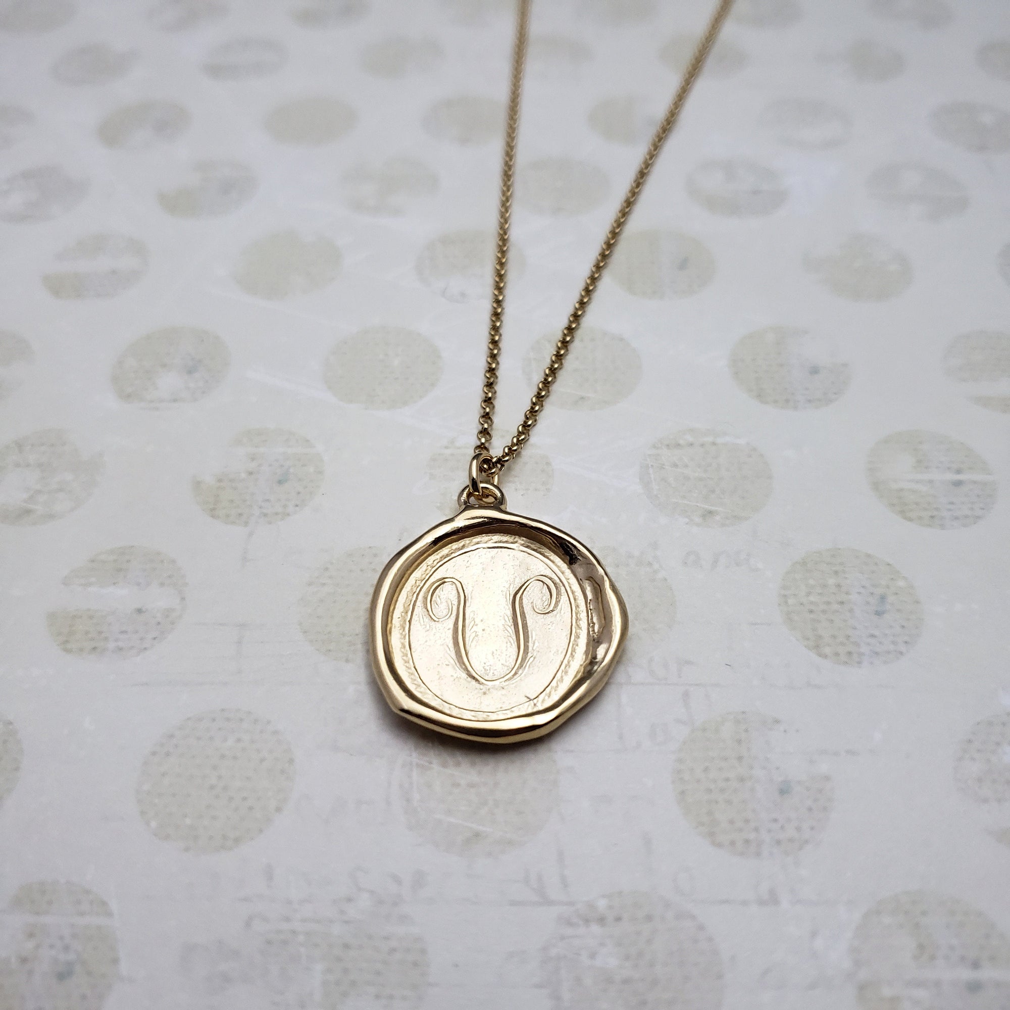 Letter U in gold vermeil