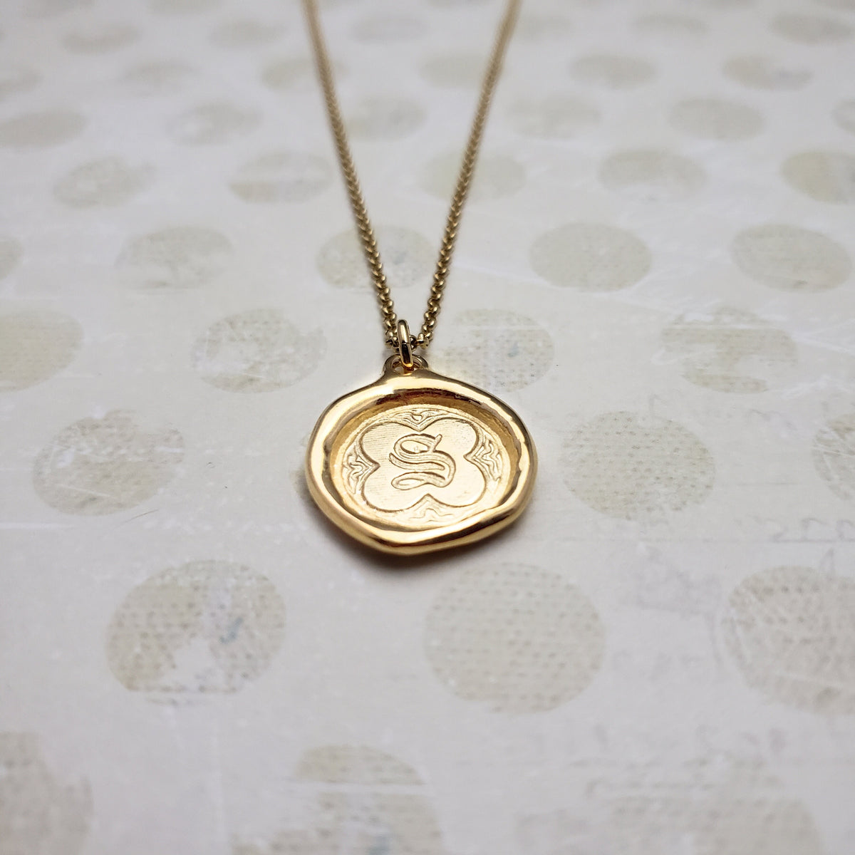 Letter S in gold vermeil