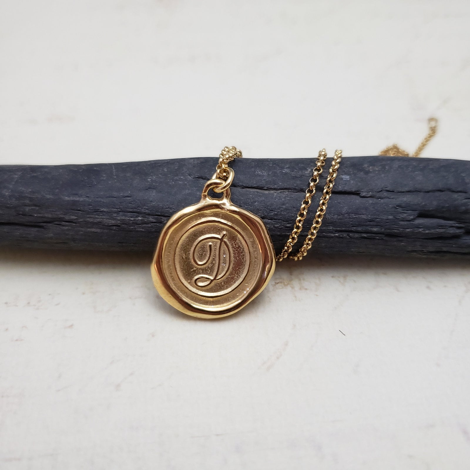 Letter D in gold vermeil