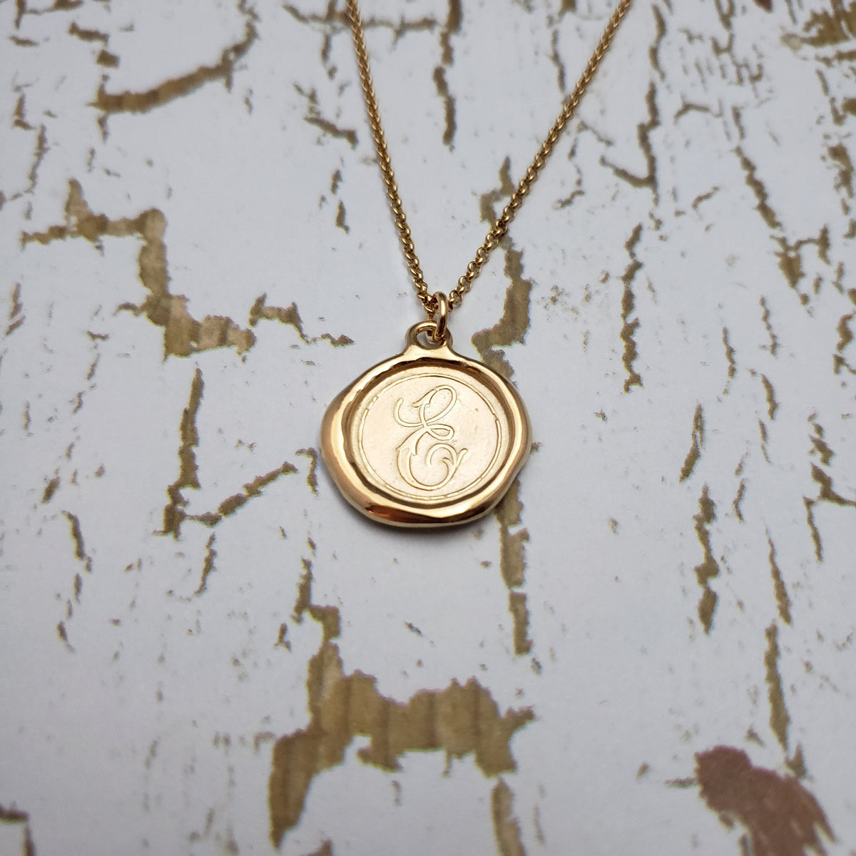 Letter E in gold vermeil