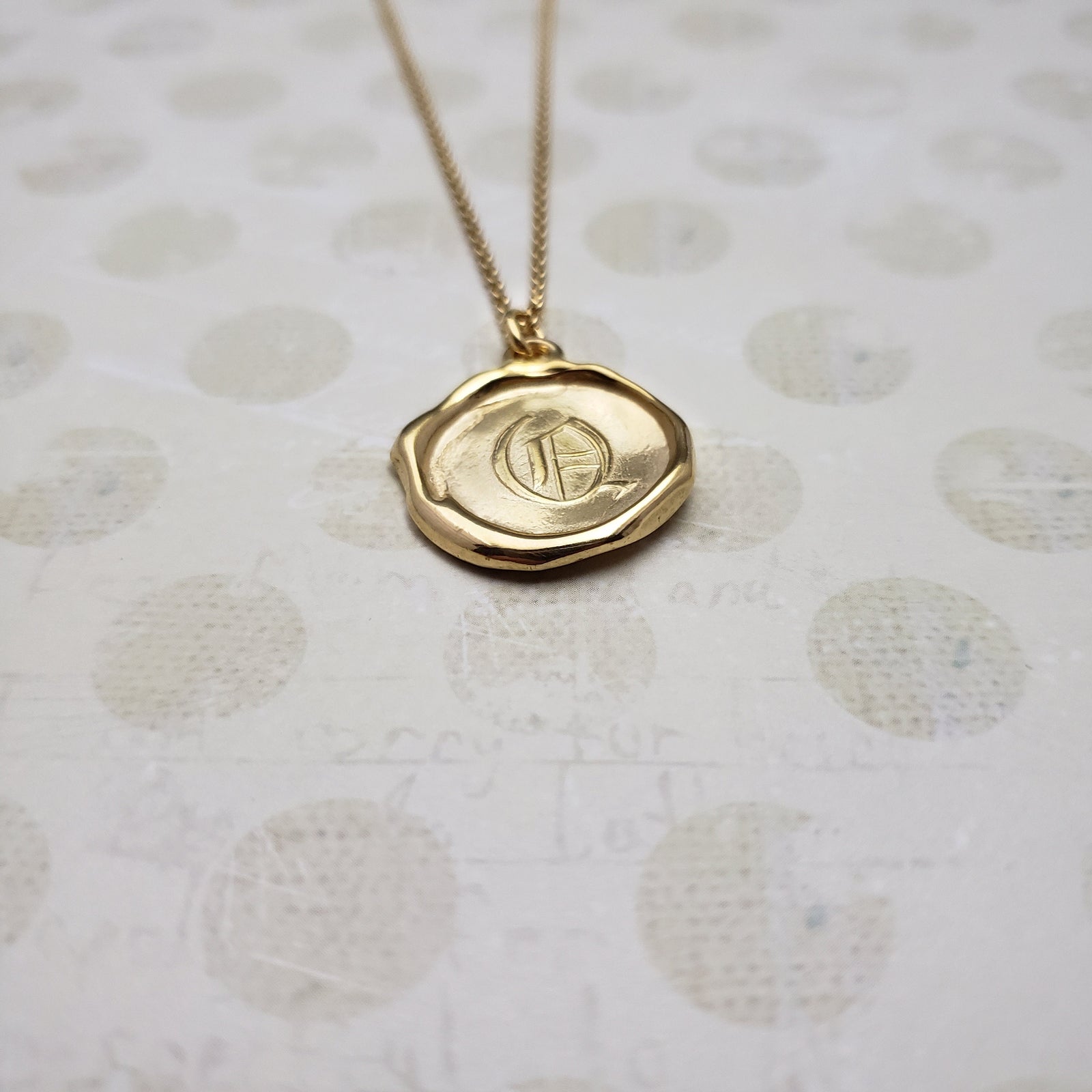 Letter Q in gold vermeil